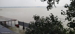 a view of a body of water with a dock at Mauni Ashram in Prayagraj +11 photos