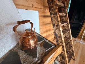 a copper tea kettle sitting on top of a table at Ryten View Retreat in Hovdan +18 photos