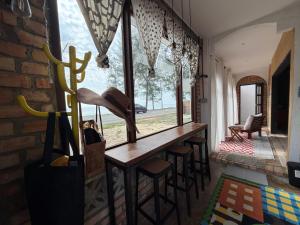 a bar with stools in a room with a window at Tamu Beradu Seaview Private Pool Villa in Dungun