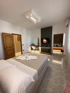 a bedroom with two beds and a living room with a fireplace at L'Incanto Suite - B&B Surano LE in Surano
