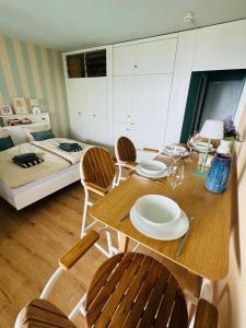 a room with a table and chairs and a bed at Ticino Lakeview Apartment in Bissone