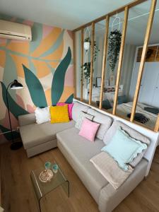 a living room with a couch with colorful pillows at Ticino Lakeview Apartment in Bissone