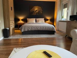 a bedroom with a bed with a black wall at Przy Jeziorze in Złotów