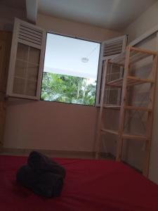 a bedroom with a bunk bed and a window at Le petit coin de campagne in Le Robert +2 photos
