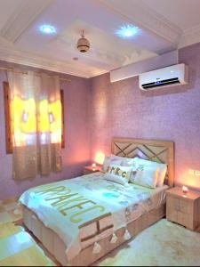 a bedroom with a large bed with purple walls at Oasis Menara in Marrakesh