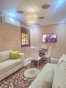 a living room with a couch and a table with a laptop at Oasis Menara in Marrakesh