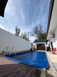 a swimming pool in the backyard of a house at Tamu Beradu Seaview Private Pool Villa in Dungun +15 photos