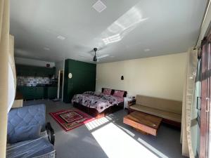 a bedroom with a bed and a couch at Ashirwad Homestay in Bhowāli