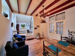 a living room with a wooden table and chairs at De Grote Belt in Oene