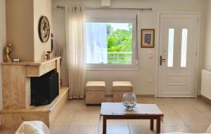 a living room with a fireplace and a table at Zoe By The Sea in Paralia Katerinis +31 photos