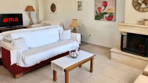 a living room with a bed and a fireplace at Zoe By The Sea in Paralia Katerinis