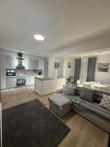 a living room with a couch and a kitchen at Tropea Home Free Private Parking in Tropea