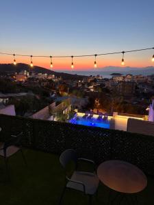 a view of a city from a balcony at sunset at Vila Myrtaj in Ksamil