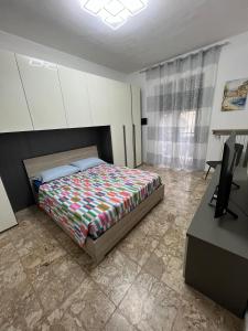 a bedroom with a bed and a desk and a television at Relax suite in Alessandria