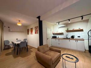 a living room with a couch and a table and a kitchen at Duplex Hause in Telavi