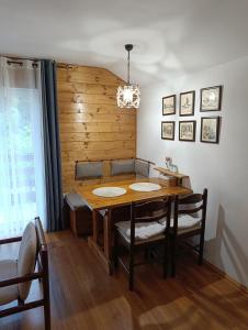 a dining room with a wooden table and chairs at Jefimija in Jasikovice