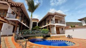 an exterior view of a house with a swimming pool at Hotel Boutique Villa Roma in Villa de Leyva