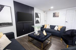 a living room with a couch and a tv at Minimal 1bed APT basement with free parking in Yonkers