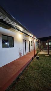 a white building with lights on the side of it at Olympia GuestHouse in Kempton Park