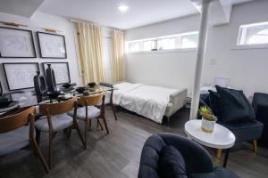 a room with a bed and a table and chairs at Minimal 1bed APT basement with free parking in Yonkers