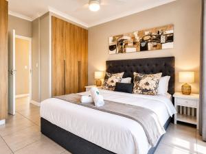 a bedroom with a large bed with two pillows on it at Ocean's Edge Escape! in Ballito