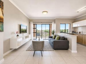 a living room with a couch and a table at Ocean's Edge Escape! in Ballito