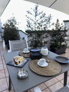 a table with food and cups and plates on it at L'Incanto Suite - B&B Surano LE in Surano