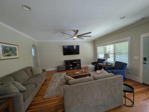 a living room with a couch and a ceiling fan at Sandnapper in Pawleys Island