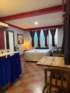 a hotel room with a bed and a table at Hostal Harvest House in León +64 photos