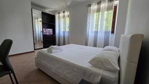a bedroom with a bed and a chair and a mirror at Fuga in Valpolcevera Comfort e Relax in Mignanego