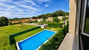 a view of a swimming pool from a window of a house at Las Xanas · Vistas, Piscina y Terraza en LLanes in Llanes