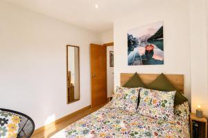 a bedroom with a bed and a picture on the wall at Las Xanas · Vistas, Piscina y Terraza en LLanes in Llanes