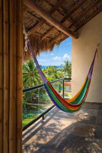 a colorful hammock hanging from a building at Jardín del Mar by ÓOL Hotels in Holbox Island