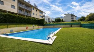 a swimming pool in the middle of a grass field at Las Xanas · Vistas, Piscina y Terraza en LLanes in Llanes +28 photos