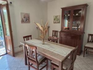 a dining room with a table with chairs and a cabinet at Alloggio turistico borgo antico in Bagnaia
