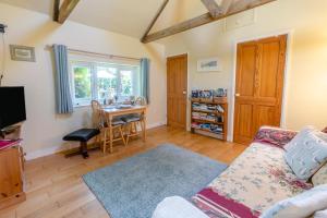 a living room with a couch and a table at 1 Bed in Falmouth oc-85594 in Constantine