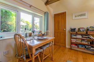 a dining room with a table and chairs and a window at 1 Bed in Falmouth oc-85594 in Constantine