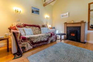 a living room with a couch and a fireplace at 1 Bed in Falmouth oc-85594 in Constantine