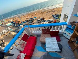 a balcony with a view of a beach and the ocean at Soft Sand Beach in Taghazout