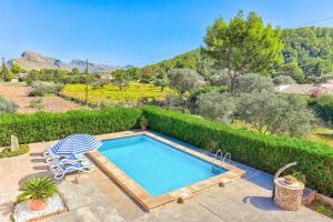 a swimming pool with a chair and avisorvisor at Villa Oliver by Villa Plus in El Port