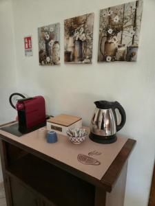 a counter with a tea kettle and a toaster on it at Alloggio turistico borgo antico in Bagnaia