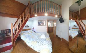 a bedroom with a bunk bed and a staircase at FREE DOG STAY - LARGE APARTMENT - FREE PUBLIC PARKING BEDROOM TV, WALK in SHOWER - FULL Kitchen - NETFLIX - Super Fast WiFi - DVD's-Welcome Tray - No Deposits - Just Meters from Gavin n Stacey Film House in Barry