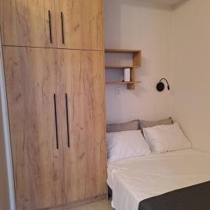 a bedroom with a large wooden cabinet next to a bed at Lydia's Apartment in Tripoli