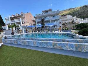 a large swimming pool in front of a building at Arba Seaview Residences Apartments in Mlini