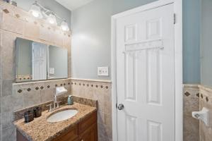 a bathroom with a sink and a mirror at Retro 3BR Walkup Apt and Shared Yard and Parking in Yonkers +19 photos