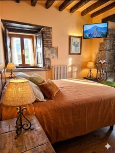 a bedroom with a large bed with two lamps at Posada Campo in Suances