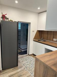 a kitchen with a refrigerator in the middle of a room at Casa Andora Brașov in Braşov +3 photos