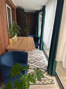 a room with a table and chairs and plants at Casa Andora Brașov in Braşov