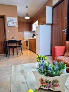 a kitchen and a living room with a white refrigerator at Lemon tree House in Skala Marion