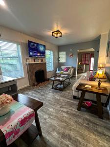 a living room with a couch and a fireplace at Coastal Bungalows--The Flamingo Bungalow in Fort Lauderdale
